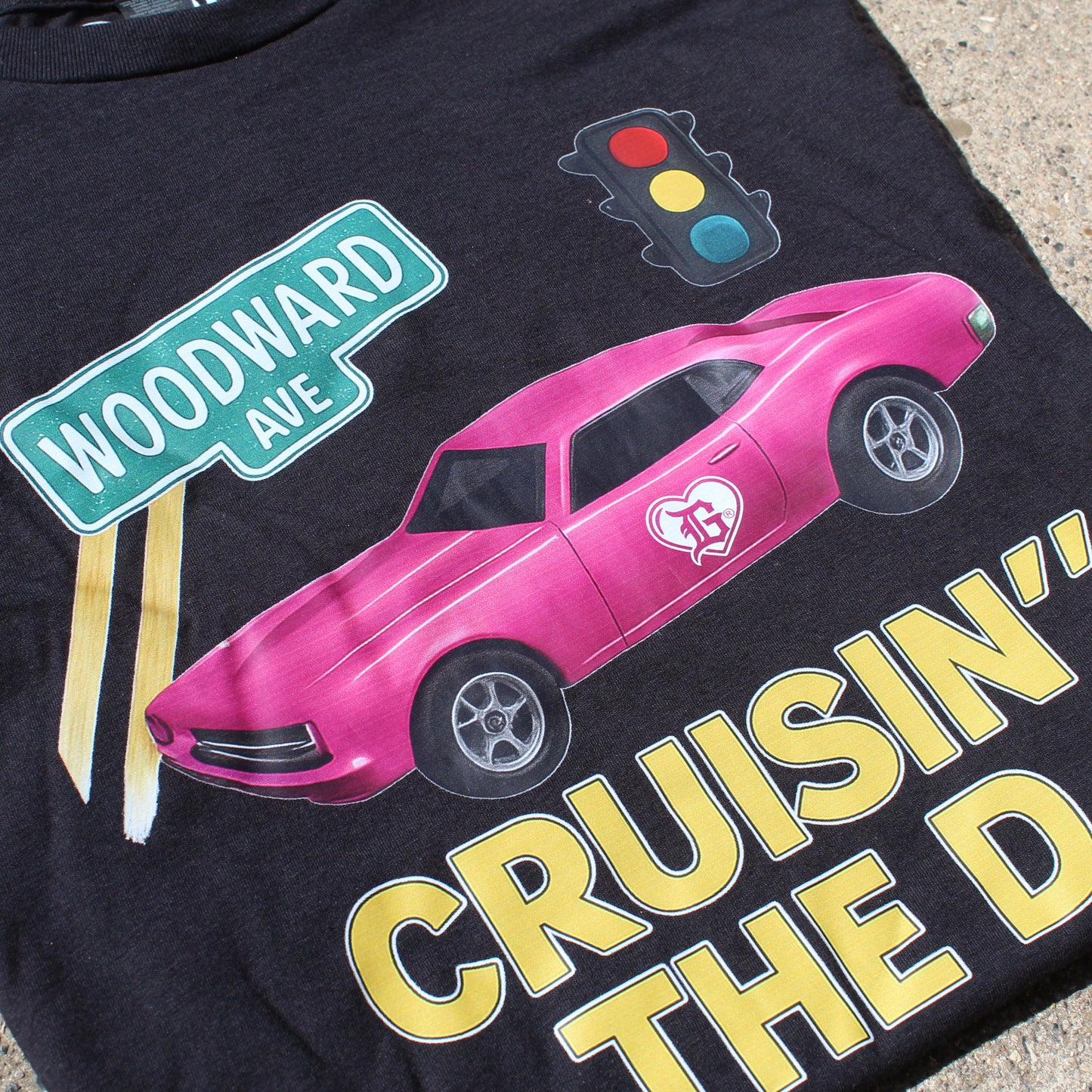 Black t-shirt with pink car graphic and text 'Cruisin' the D' on a street background