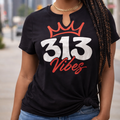 Woman wearing a black t-shirt with '313 Vibes' design in an urban setting