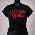 Black t-shirt with 'I'm a Detroit Girl' text on a mannequin against a gray background