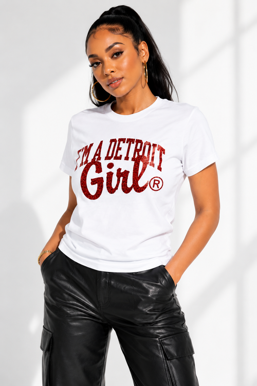 Woman wearing a white t-shirt with 'I'm a Detroit Girl' text on a light gray background