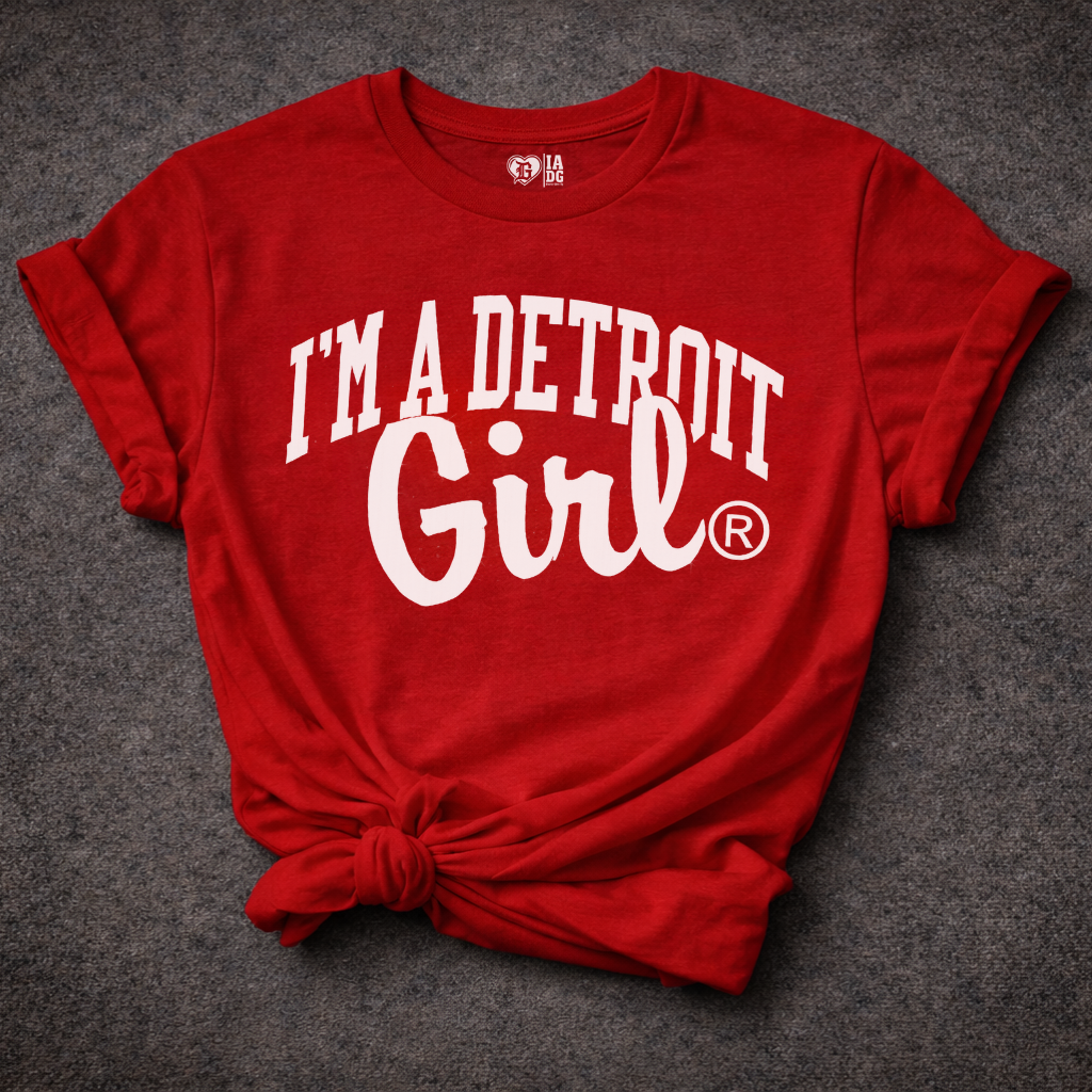 Red t-shirt with 'I'm a Detroit Girl' text on a dark textured background